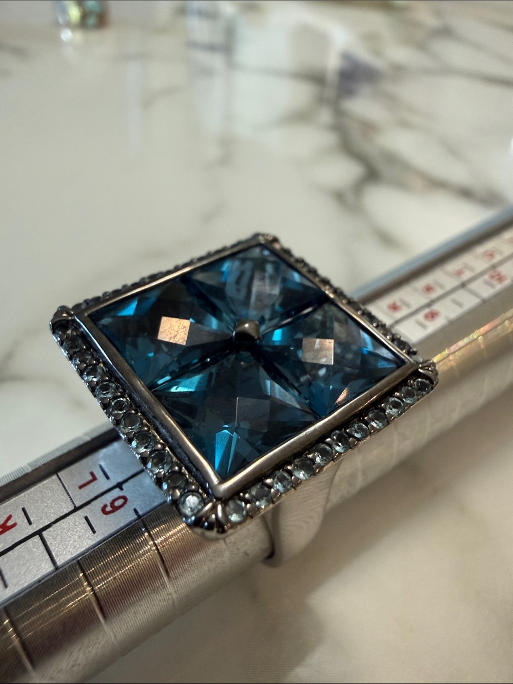 Silver ring with blue stones in checkerboard setting